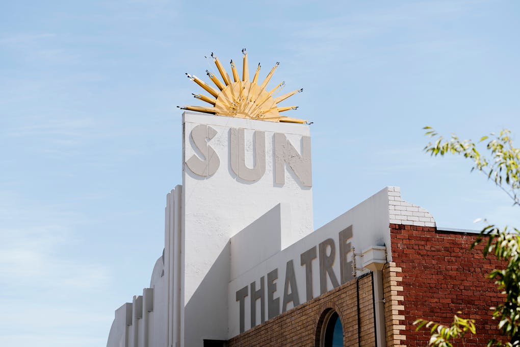 The sign of the Sun Theatre Yarraville with a large sun in the blue sky.